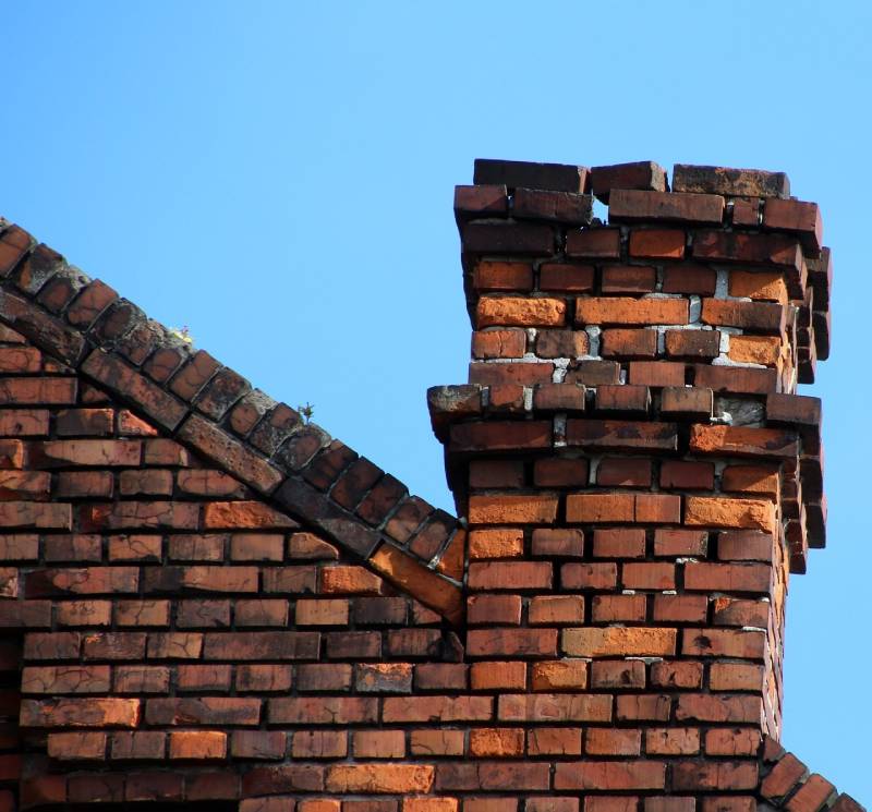 Signs Your Romeo Home Needs a Chimney Inspection Damaged chimney on an Romeo home showing cracks and missing mortar
